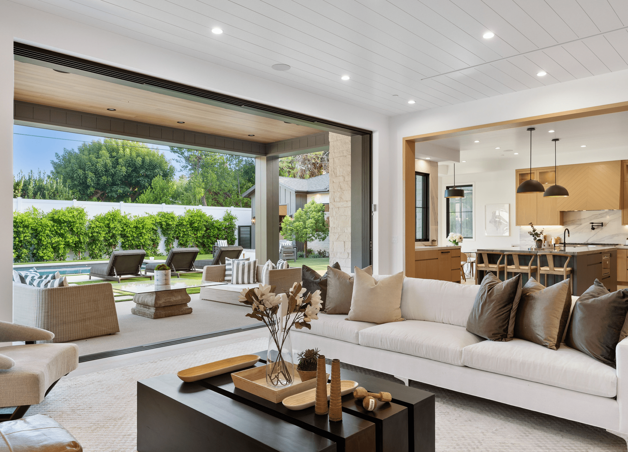 Modern living room with open patio and stylish furniture.