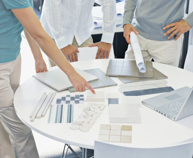 Designers discussing material samples at table