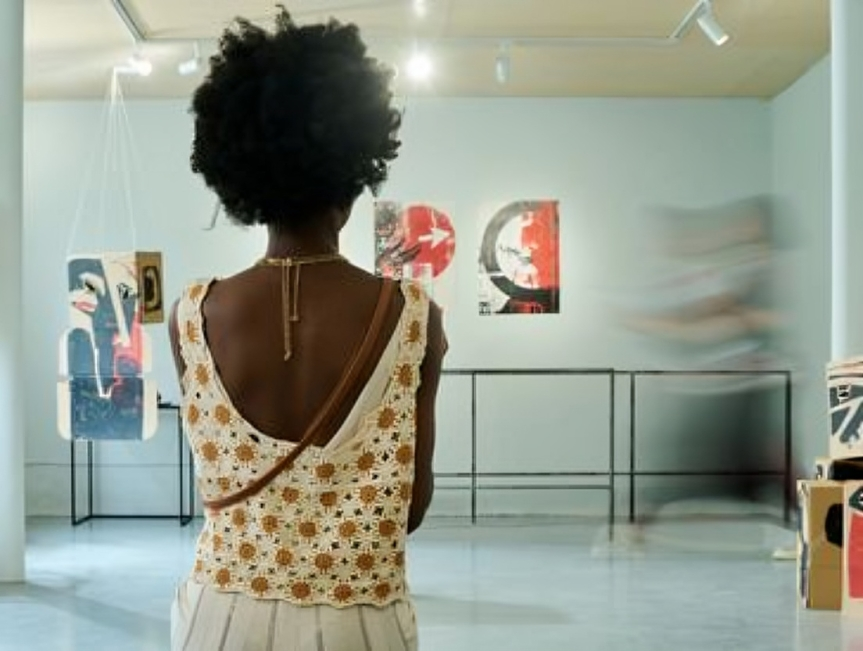 Woman admiring abstract paintings